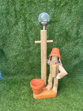 Little girl or boy with a tall lamp post