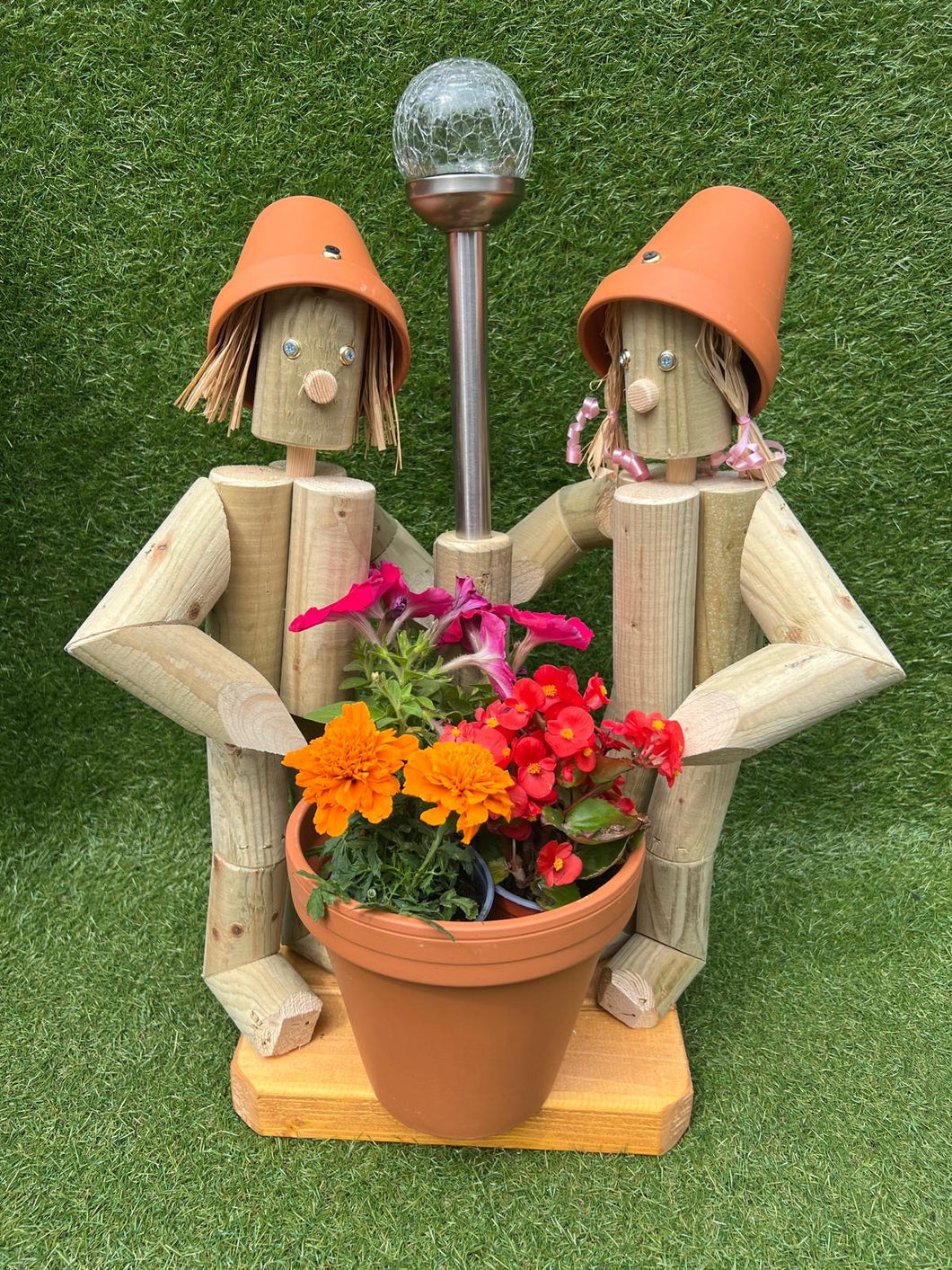 Couple holding a pot with solar lamp