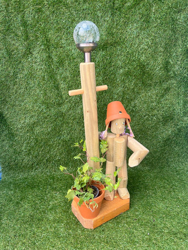Little girl or boy with a tall lamp post