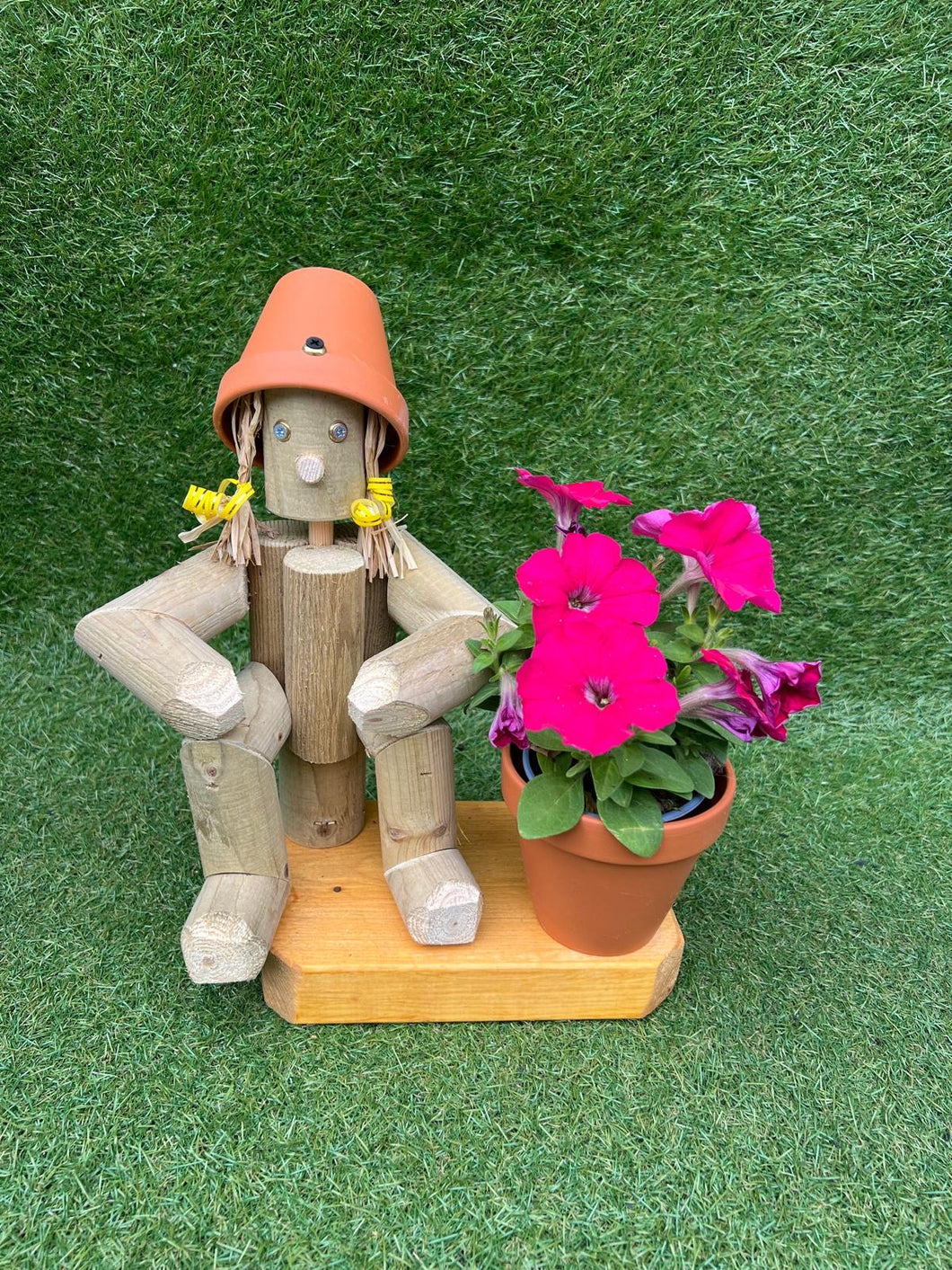 Small,sitting girl holding a pot