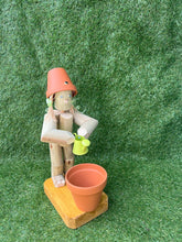 Little Girl or Boy holding a watering can