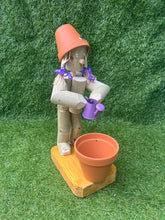 Little Girl or Boy holding a watering can