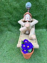 Man on a deck chair with a solar lamp